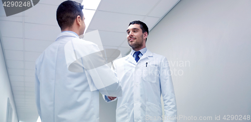 Image of smiling doctors at hospital doing handshake