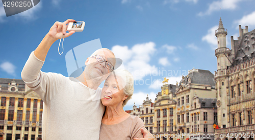 Image of senior couple with camera traveling in brussels
