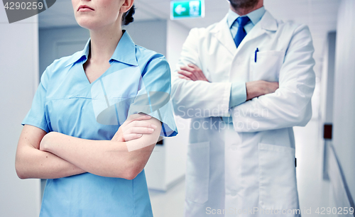 Image of close up of doctor and nurse at hospital corridor