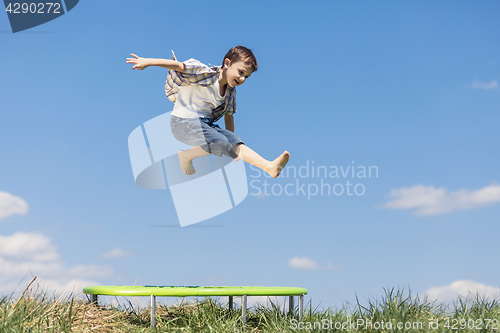 Image of Little boy playing on the field at the day time. 