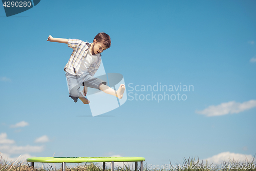 Image of Little boy playing on the field at the day time.