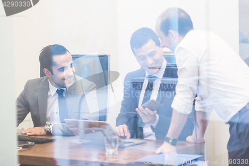 Image of Cheerful relaxed corporate businessteam working in modern office.