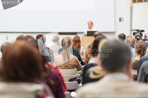 Image of Woman giving presentation in lecture hall at university.