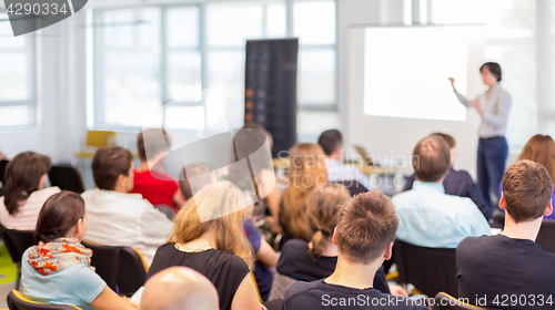 Image of Woman giving presentation on business conference.