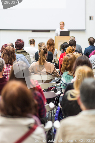 Image of Woman giving presentation in lecture hall at university.