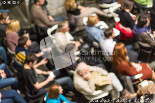 Image of Blured audience in conference hall shot from abowe.