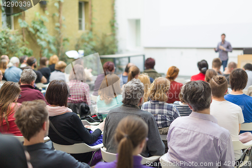 Image of Man giving presentation in lecture hall at university.