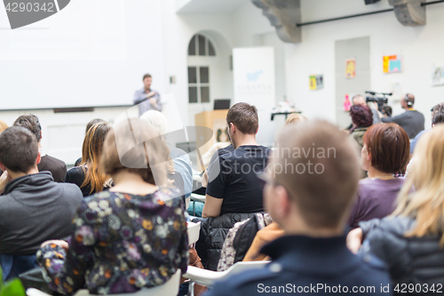 Image of Man giving presentation in lecture hall at university.