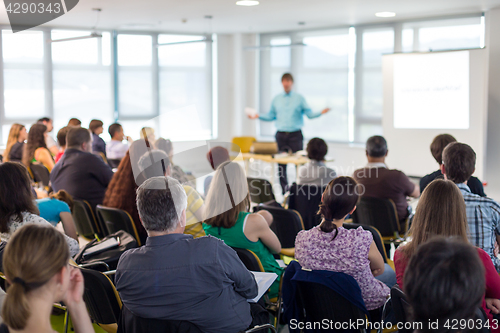 Image of Speaker giving presentation on business conference.