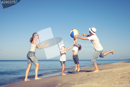 Image of Happy family walking on the beach at the day time.