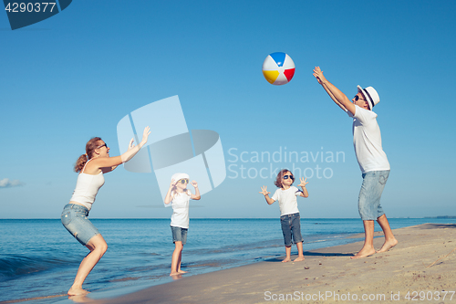 Image of Happy family walking on the beach at the day time.