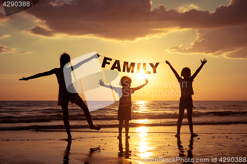 Image of happy children playing on the beach