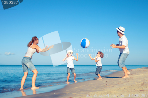 Image of Happy family walking on the beach at the day time.