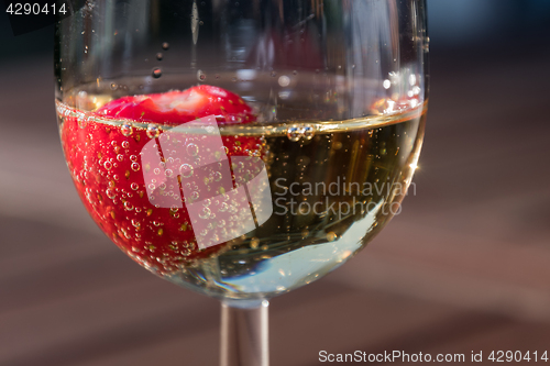 Image of Strawberry in a glass sparkling wine close up