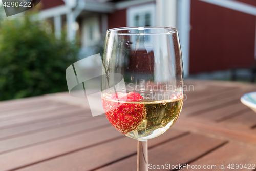 Image of Glass with a strawberry in sparkling wine