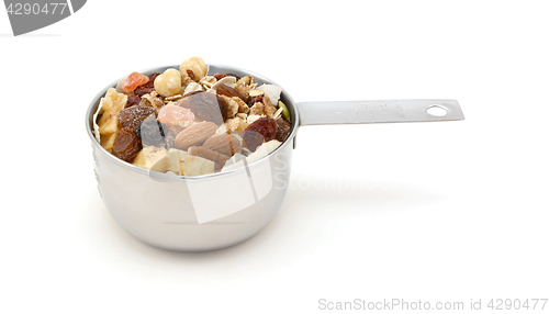 Image of Muesli cereal with fruit and nuts in a measuring cup