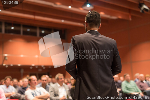 Image of Public speaker giving talk at Business Event.