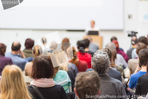 Image of Woman giving presentation in lecture hall at university.