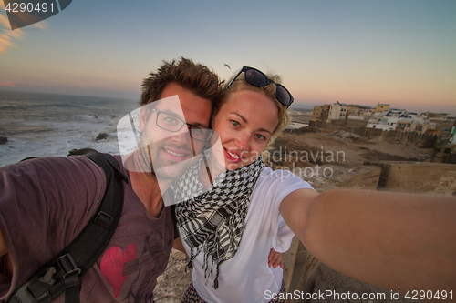 Image of Traveler couple taking selfie on city fortress wall of Essaouira, Morocco.