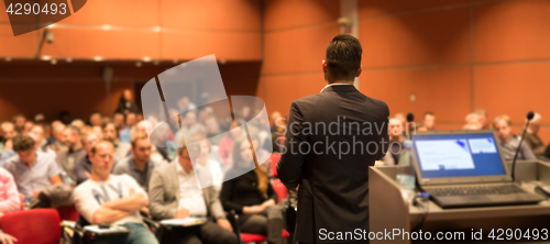 Image of Public speaker giving talk at Business Event.