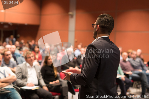 Image of Public speaker giving talk at Business Event.