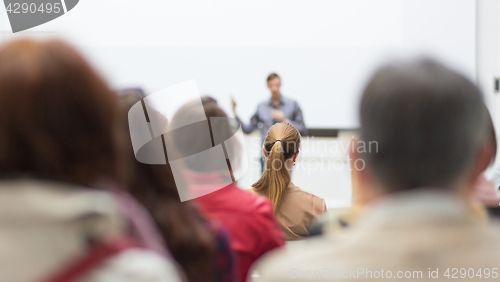Image of Man giving presentation in lecture hall at university.