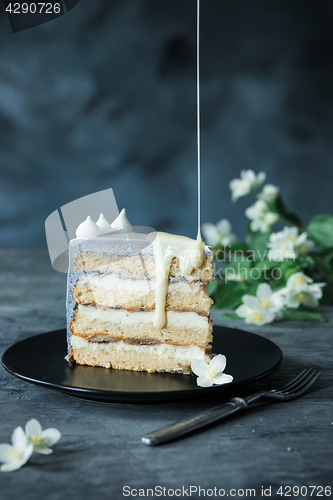 Image of Slice of Birthday Cake with a flowers over a blue background.