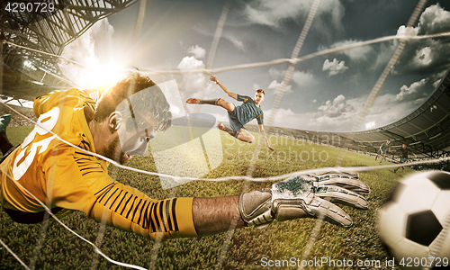 Image of Goalkeeper in gates jumping to catching ball