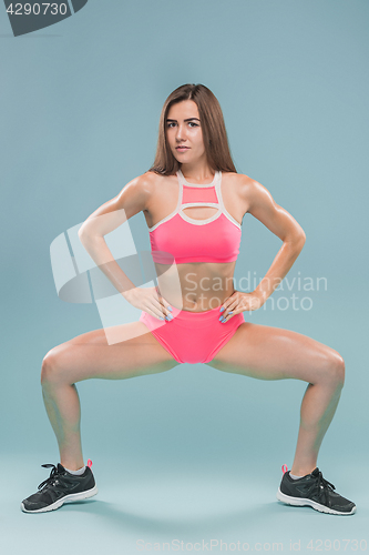 Image of Muscular young woman athlete posing at studio