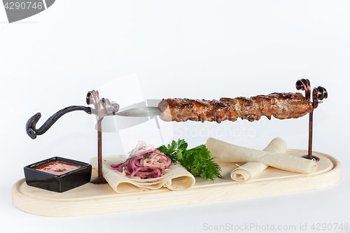 Image of Close Up of Rack of Saucy Barbecue Pork Served on Plate in Restaurant