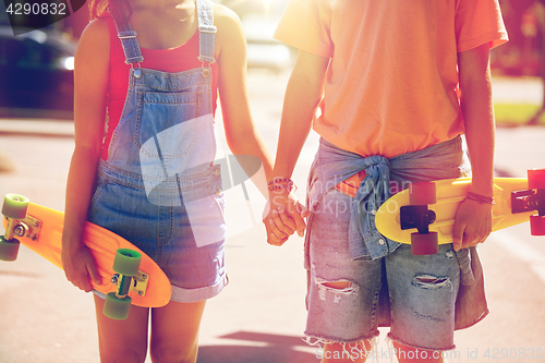 Image of close up of young couple with skateboards in city