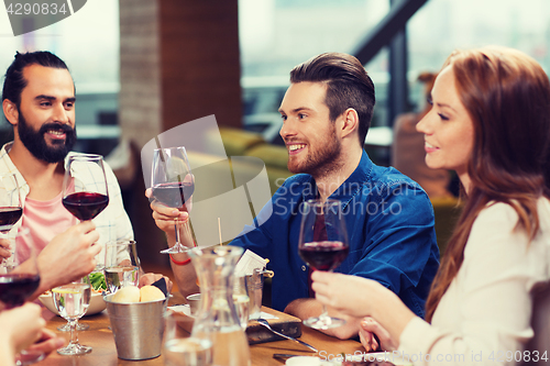 Image of friends dining and drinking wine at restaurant