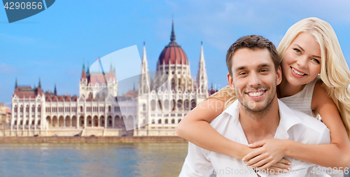 Image of happy couple over house of parliament in budapest