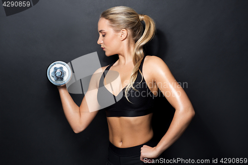 Image of young sporty woman exercising with dumbbell