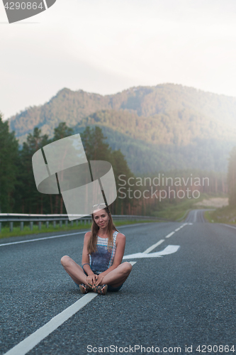 Image of Woman sitting on the road