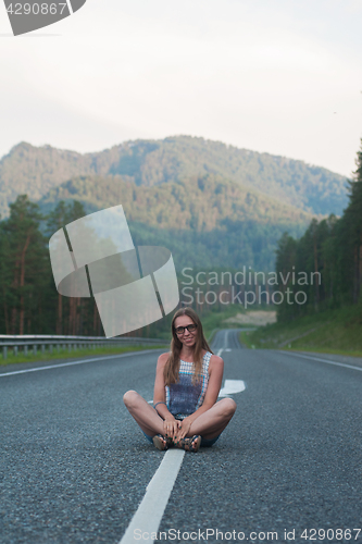 Image of Woman sitting on the road