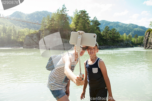 Image of selfie on mobile phone with stick