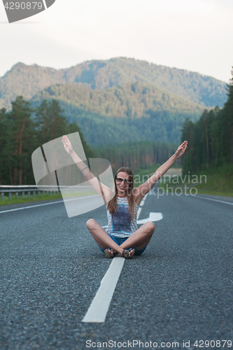 Image of Woman sitting on the road