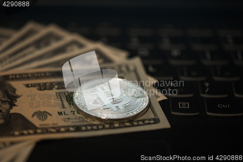 Image of Bitcoin coin with dollars