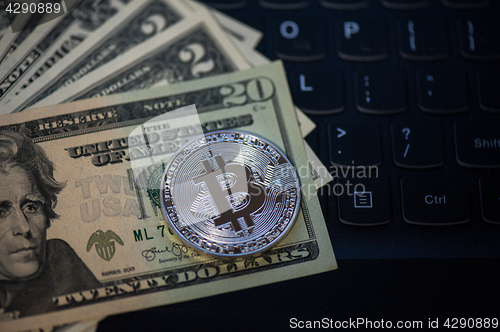 Image of Bitcoin coin with dollars