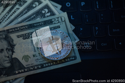 Image of Bitcoin coin with dollars