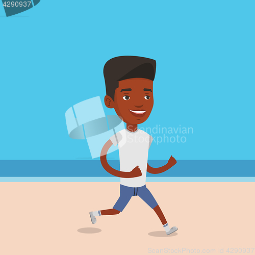 Image of Young sporty man jogging on the beach.