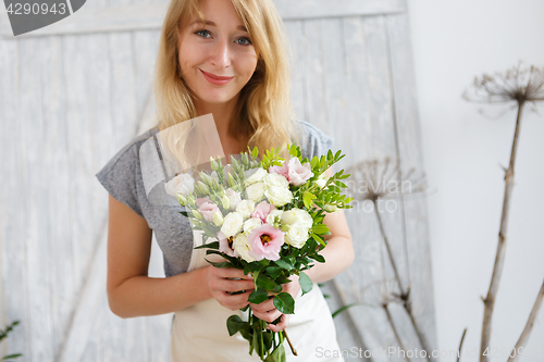 Image of Portrait of florist with bouquet