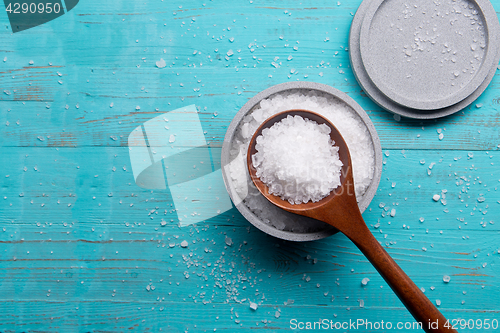 Image of sea salt in stone bowl and wooden spoon