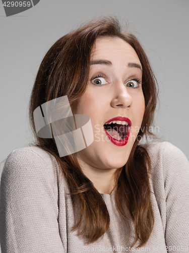Image of Portrait of young woman with shocked facial expression