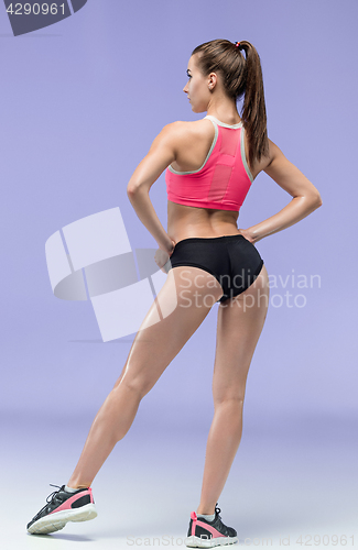 Image of Muscular young woman athlete posing at studio