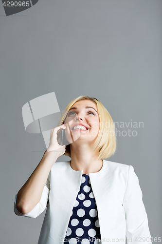 Image of Beautiful woman talking on phone
