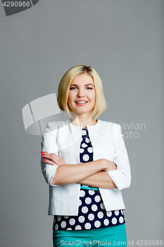 Image of Smiling woman with arms crossed