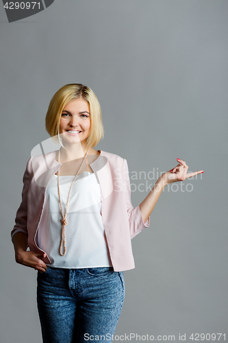 Image of Blonde pointing at empty space