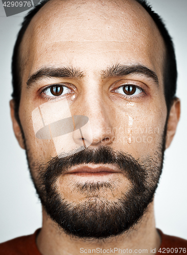 Image of The crying man with tears on face closeup